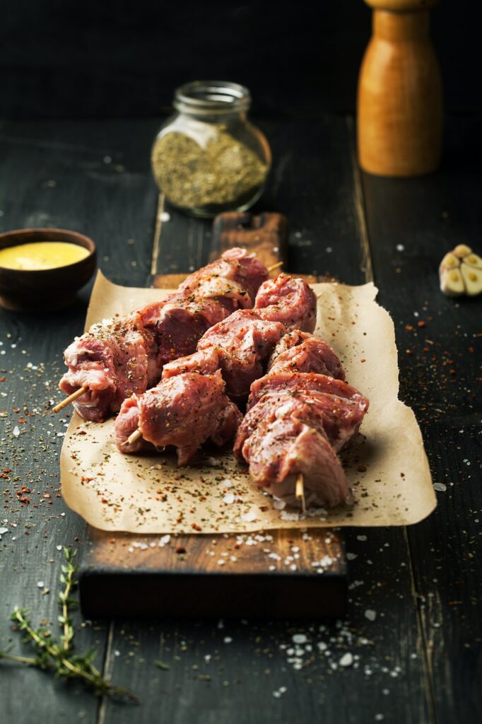 Raw meat on skewers. BBQ meat with spices